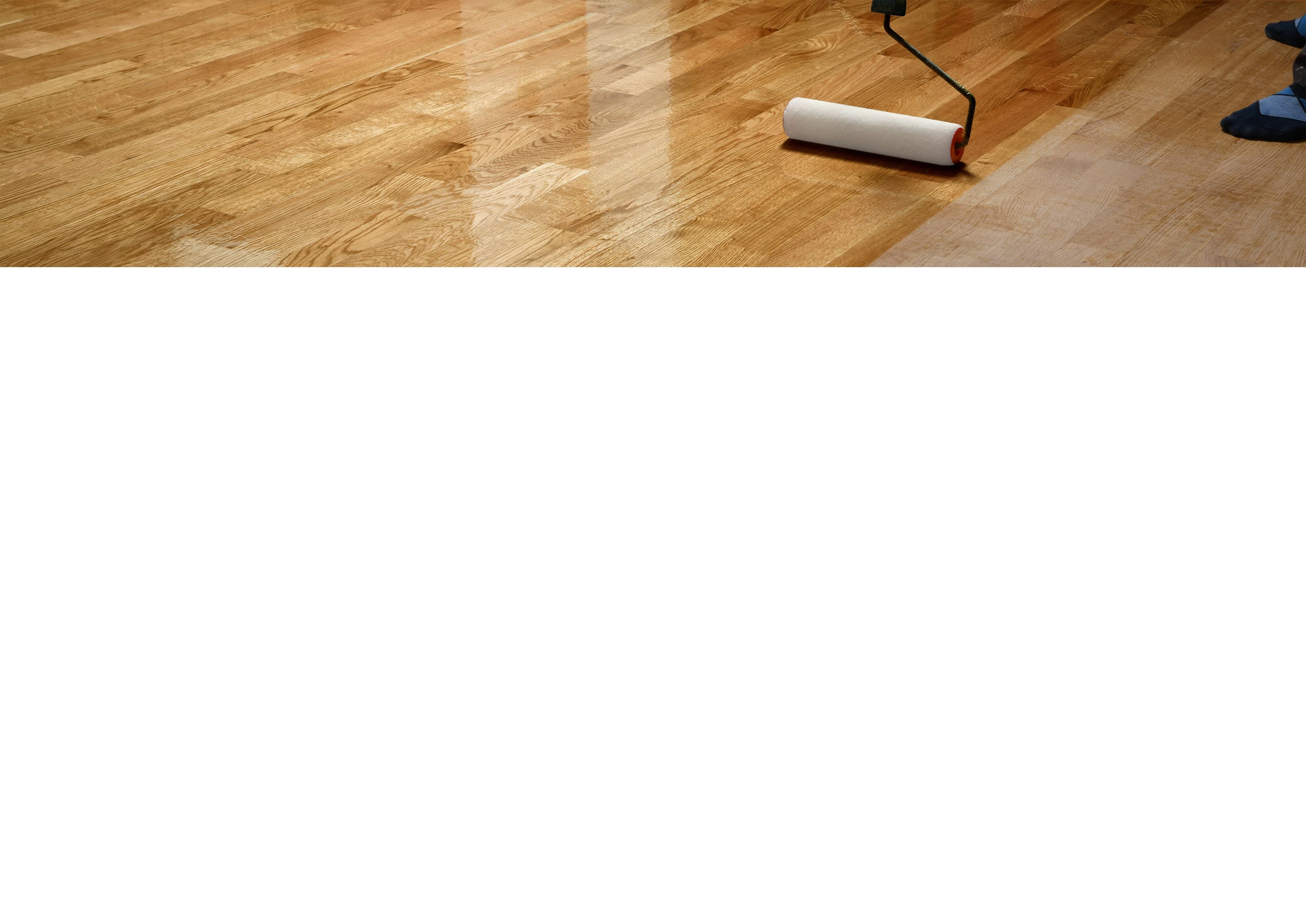 Hardwood floor with paint roller representing quality finishing