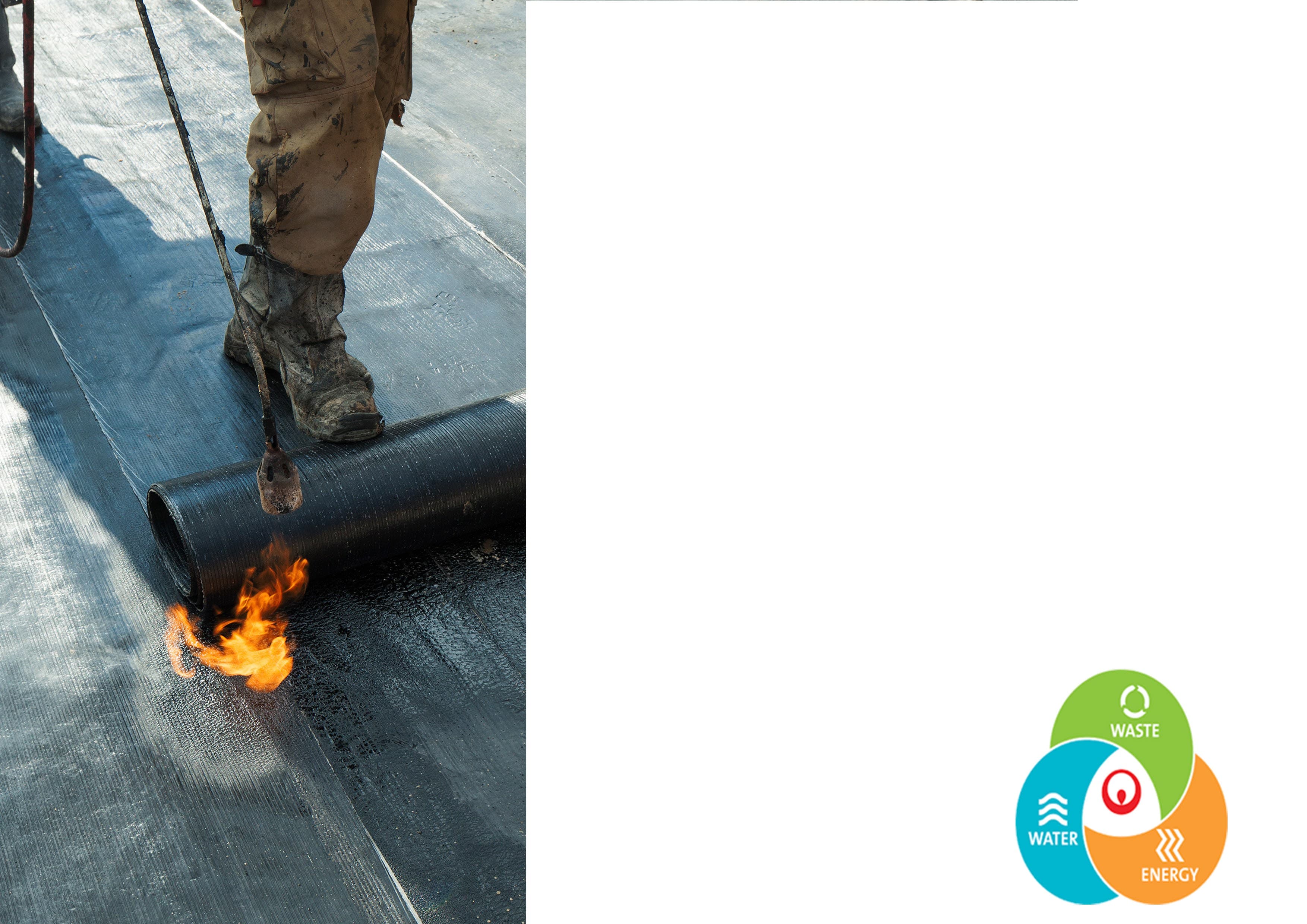 Worker applying waterproofing membrane on a construction site